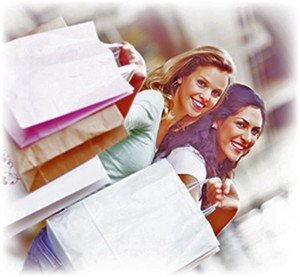 Portrait of two happy young females holding their shopping bags