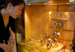 A woman looks at luxury watches displaye