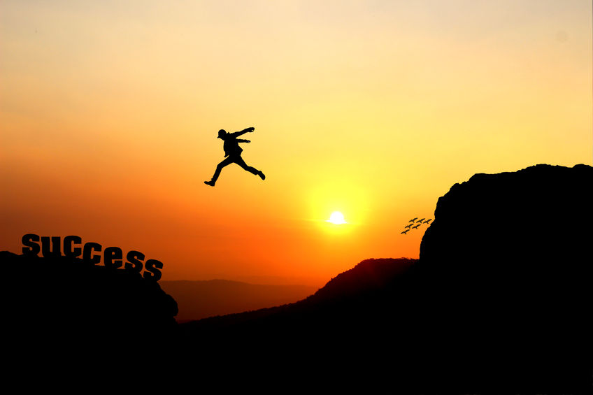 98959414 - silhouette of a man jumping over the cliff, jump go on to success